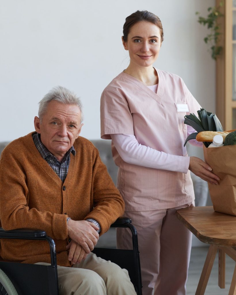 portrait-of-disabled-senior-man-with-female-caregiver.jpg